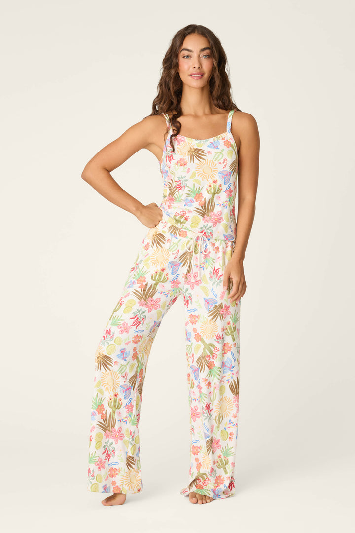 A woman with long, wavy brown hair stands barefoot against a light background, wearing the P.J. Salvage Feelin' Prickly Desert Dreams Camisole featuring a colorful desert-inspired print.