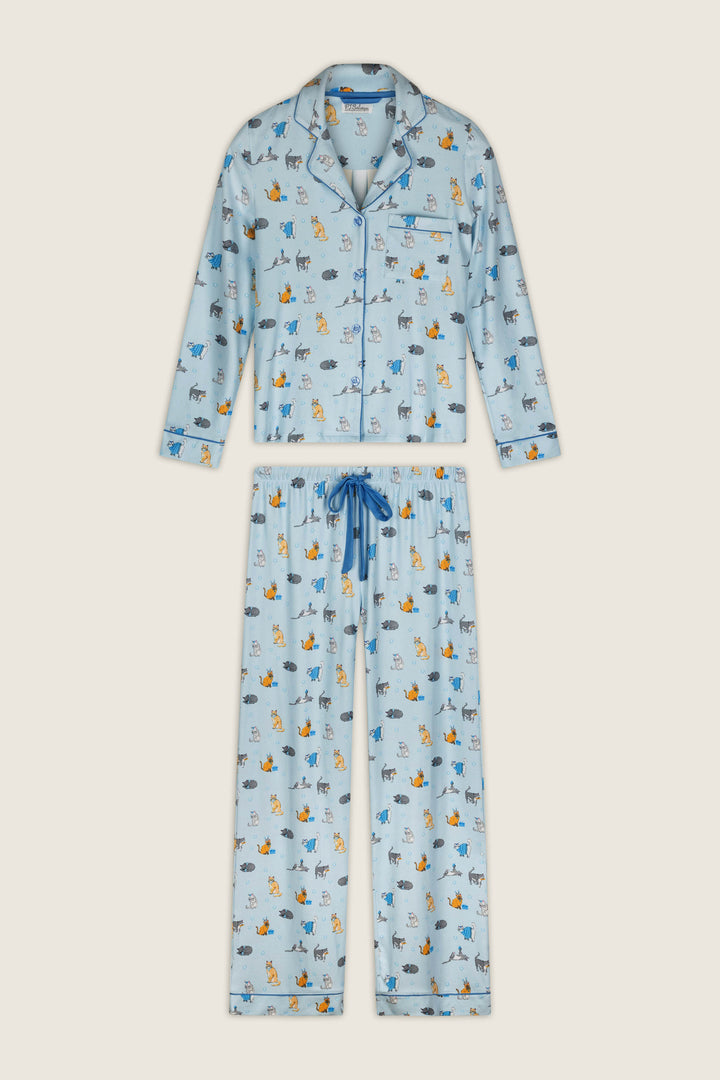 The Hanukkatz Paws for Celebration Cat Print PJ Set by P.J. Salvage features a light blue pajama set with long sleeves and pants, an all-over print of playful cartoon cats in various colors and poses, plus blue trim and a drawstring.
