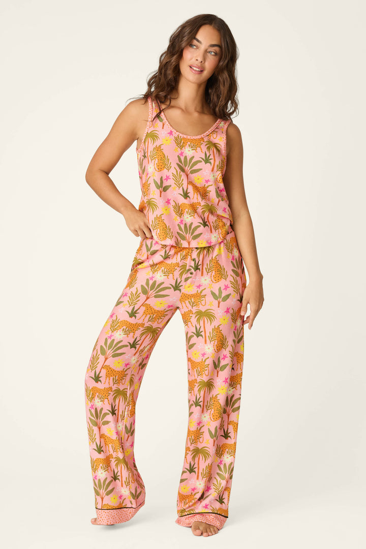 A person wearing the P.J. Salvage "In the Jungle Leopard Safari Tank Top" with matching wide-leg pants featuring orange and yellow tropical and tiger patterns, standing against a plain light background.