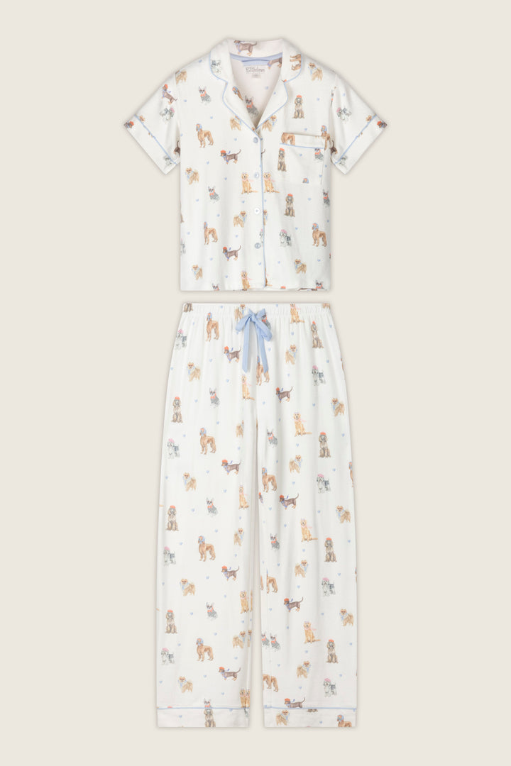 Sleep in style with the Meet Me in Pawris Dog Print 3-Piece PJ Set from P.J. Salvage, featuring a white short-sleeve button-up top with a chest pocket and playful, colorful cartoon dog prints all over. The matching pants include a blue drawstring for comfort, making this set both cute and cozy.