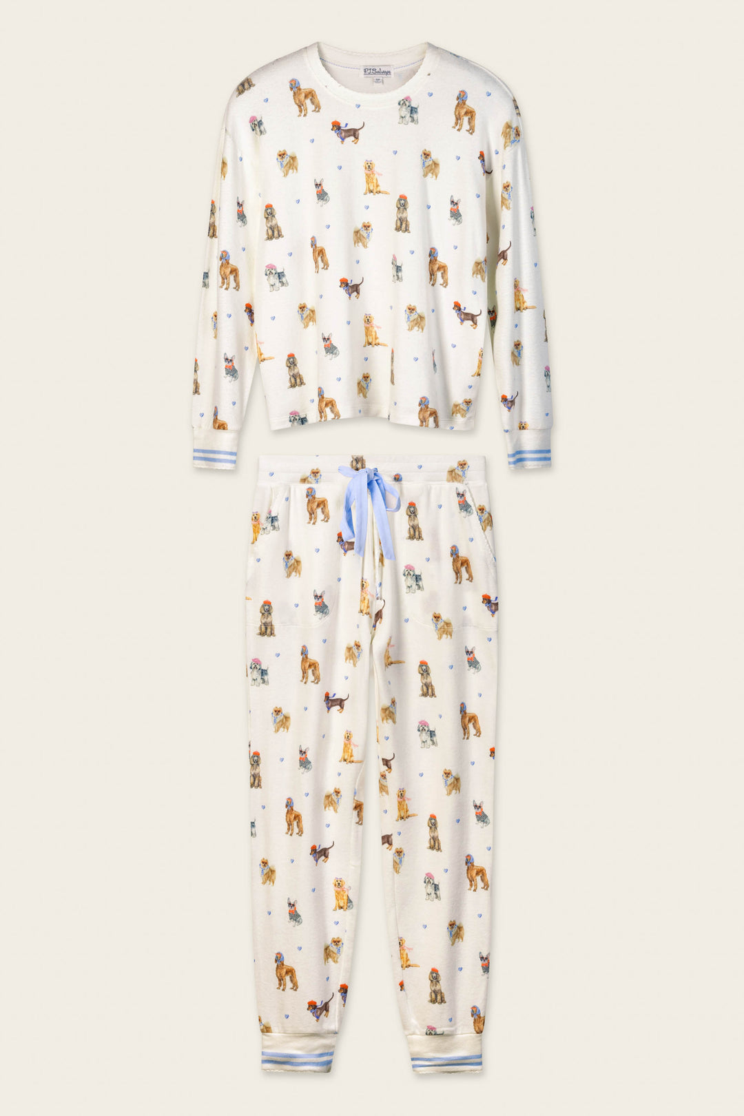 The Meet Me in Pawris Dog Print Long Sleeve PJ Set by P.J. Salvage features a white pajama set with light blue drawstring and cuffs, adorned with a playful print of small colorful dogs in various poses on a simple light beige background.