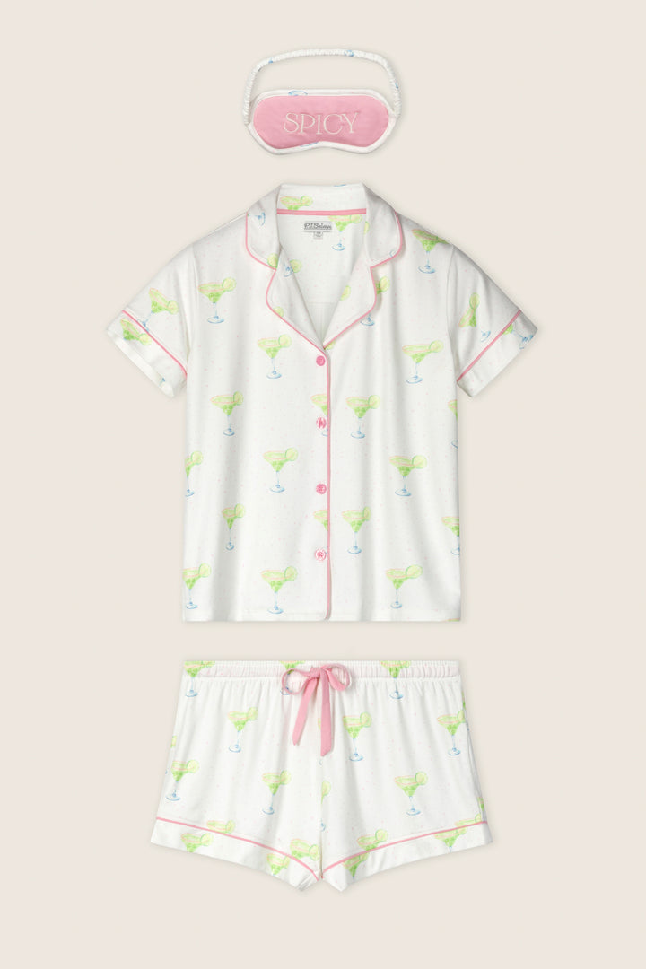 The P.J. Salvage Margarita Mama Spicy Sips 3-Piece Short PJ Set features a margarita-print short-sleeve button-up top, matching shorts with pink trim, and a pink "SPICY" embroidered sleep mask—perfect for fun, relaxing nights.