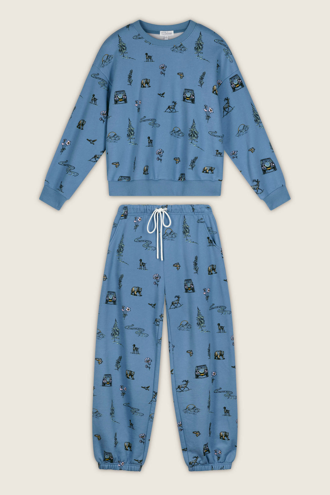 The P.J. Salvage Nature Is My Therapy Nature Print Frankie Sweatshirt features long sleeves and an all-over print of outdoor-themed illustrations, including trees, mountains, bears, and tents.