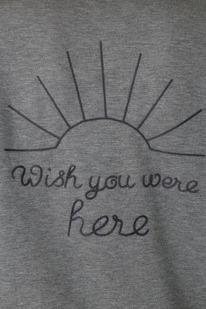 Crafted from gray fabric, the P.J. Salvage “Nature Is My Therapy Wish You Were Here Over Night Pullover” features a black stitched half-sun with rays and cursive “Wish you were here” text.