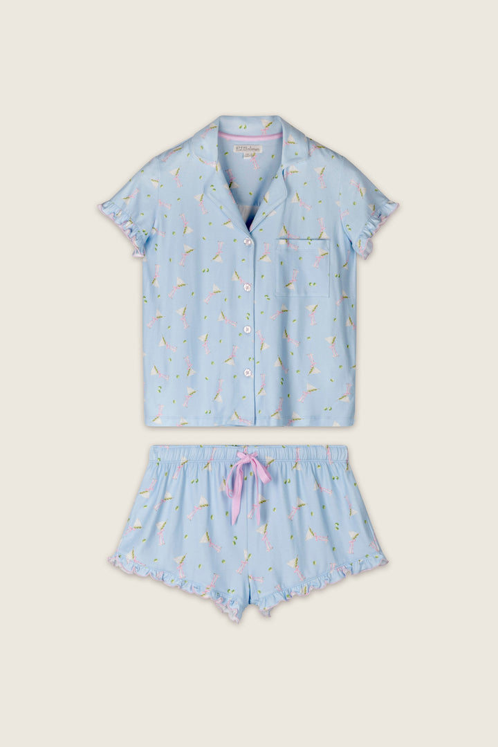 The Olive You Martini Print Short PJ Set by P.J. Salvage features a light blue, short-sleeved collared button-up top and matching shorts, both adorned with an all-over colorful martini print and finished with playful ruffle trim.