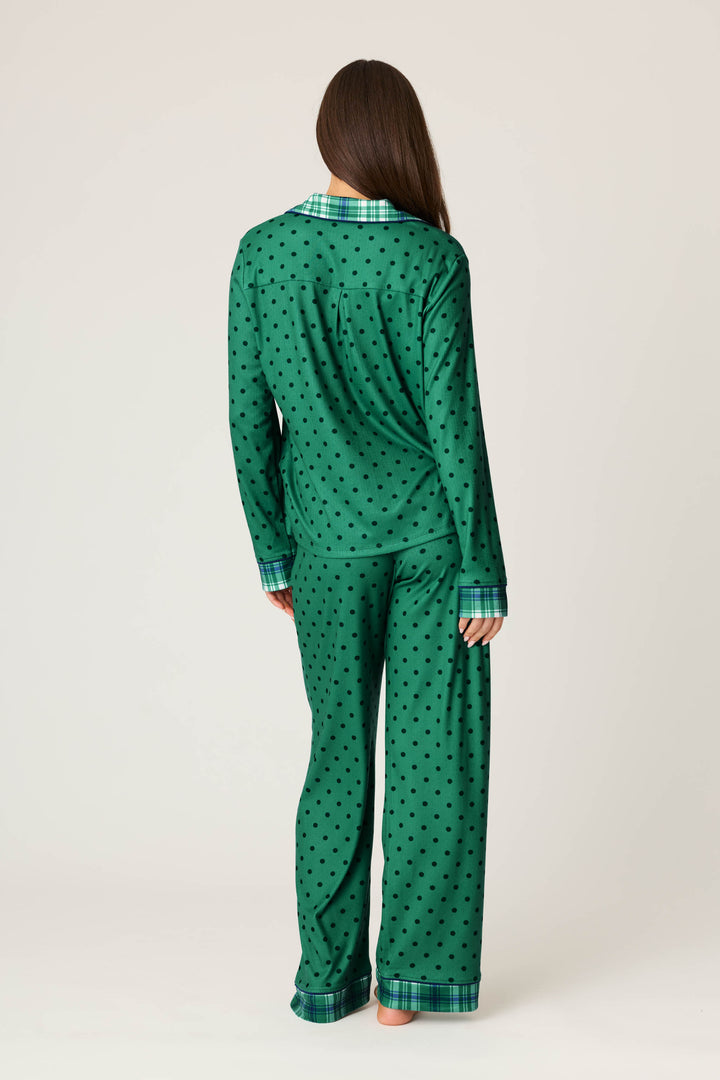 A person with long brown hair models the P.J. Salvage Plaid About You Polka Dots & Plaid PJ Set, standing with their back to the camera against a plain light background.
