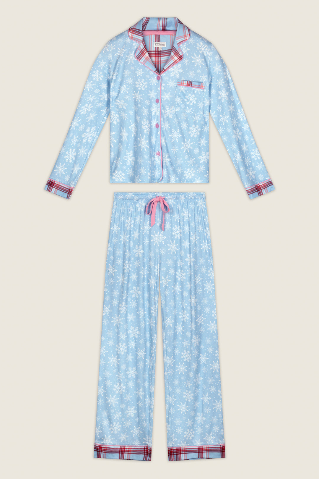 The Plaid About You Snowflakes & Plaid PJ Set by P.J. Salvage features a two-piece design with a blue snowflake pattern and red plaid trim on the collar, cuffs, and hem. The button-up top includes a chest pocket, while the pants offer a drawstring waist and plaid accents at the ankles.