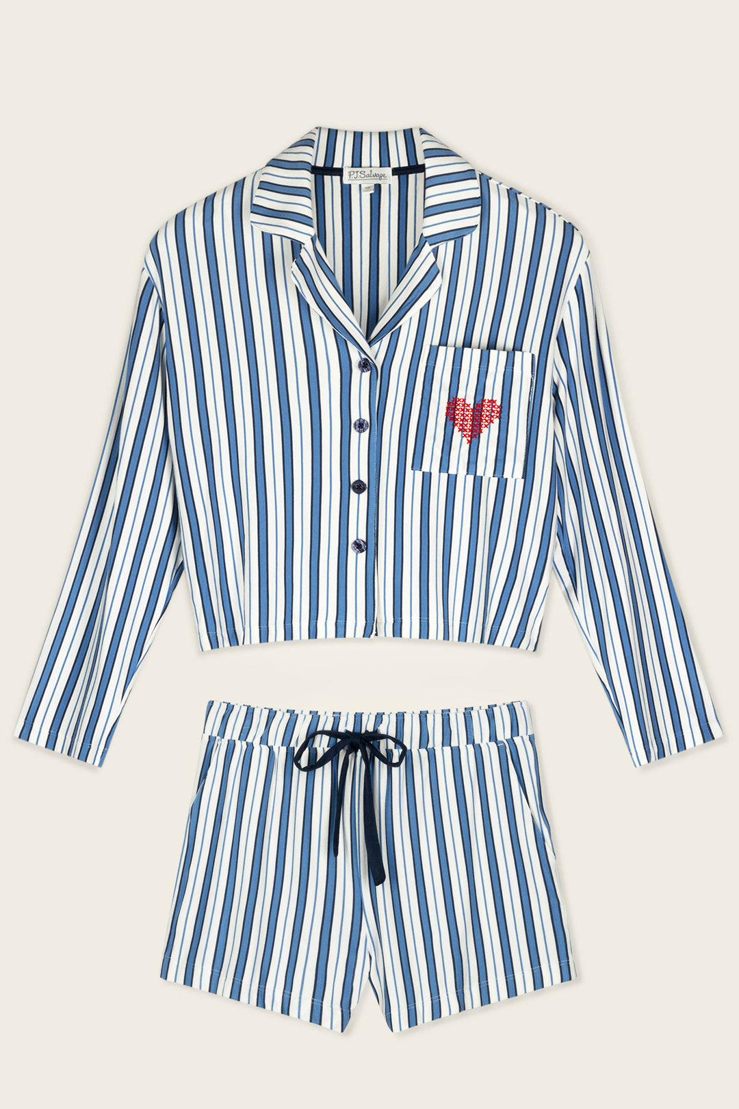 Soiree Dreams Blue Stripe Long Sleeve & Shorts PJ Set by P.J. Salvage features blue and white stripes, a cropped button-up top with a pocket adorned by a red heart design, and matching shorts with a black drawstring waistband.
