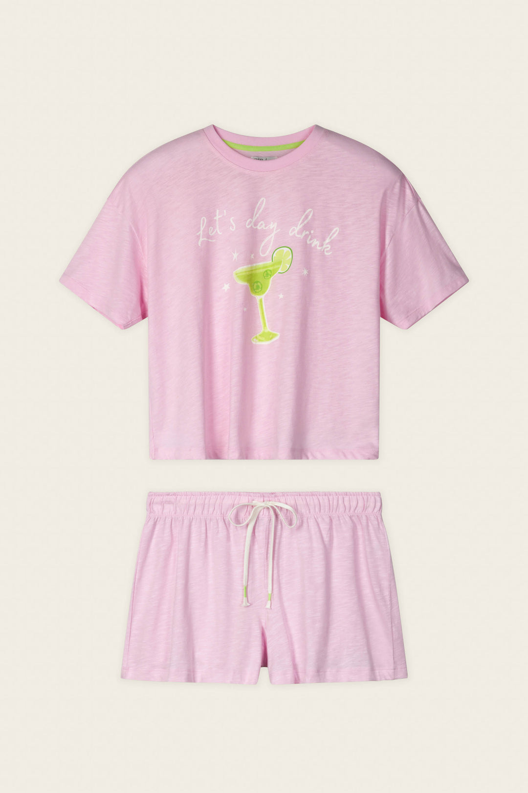 The P.J. Salvage Softee "Let's Day Drink" Graphic Print Short PJ Set includes a blush pink short-sleeve top with a fun margarita graphic and matching drawstring shorts, perfect for cozy, chic lounging.