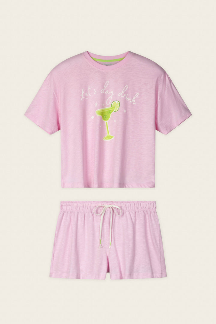 The P.J. Salvage Softee "Let's Day Drink" Graphic Print Short PJ Set includes a blush pink short-sleeve top with a fun margarita graphic and matching drawstring shorts, perfect for cozy, chic lounging.