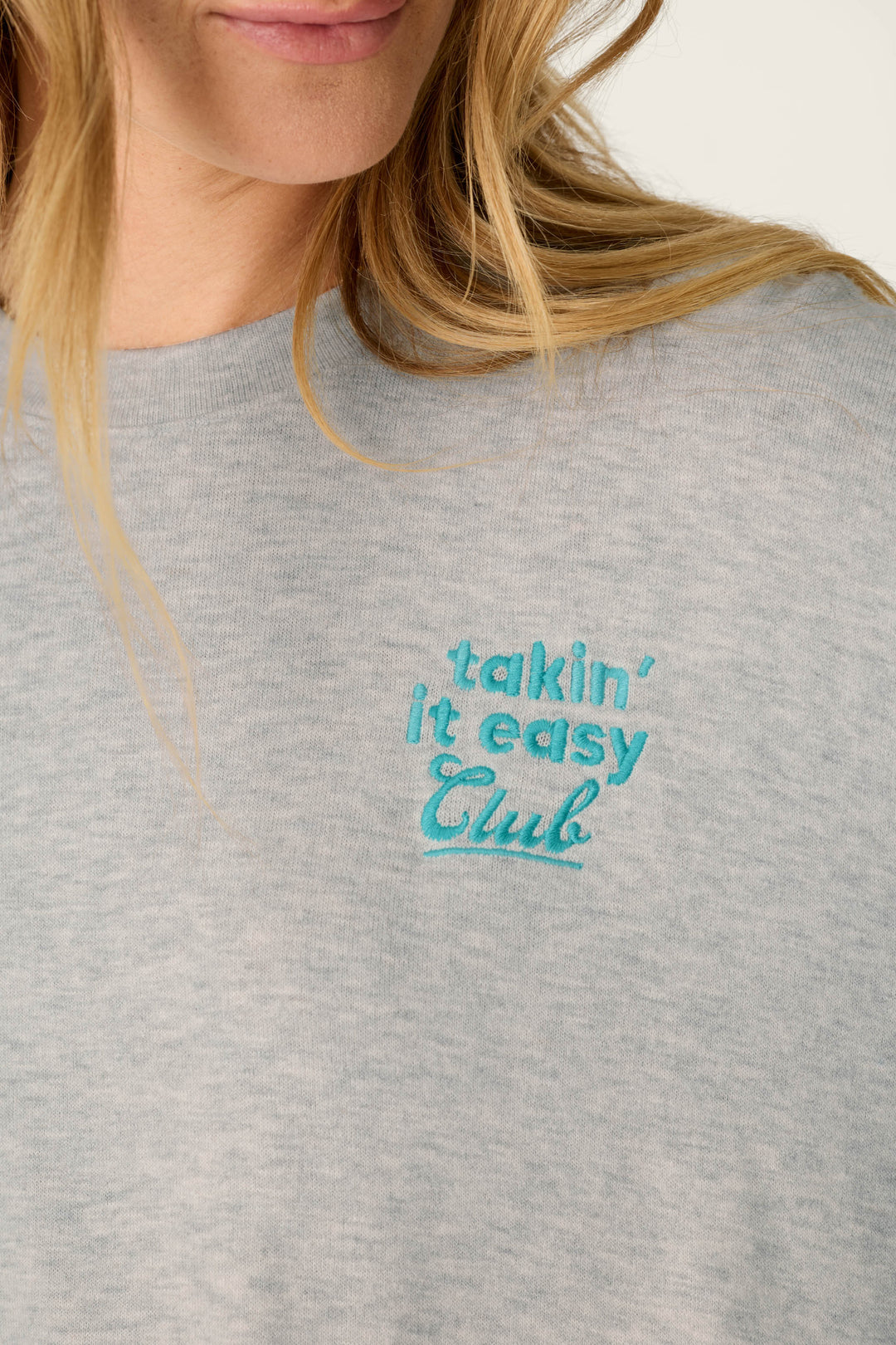 A person with long blonde hair wearing the P.J. Salvage Takin’ It Easy Club Striped Long Sleeve Top.