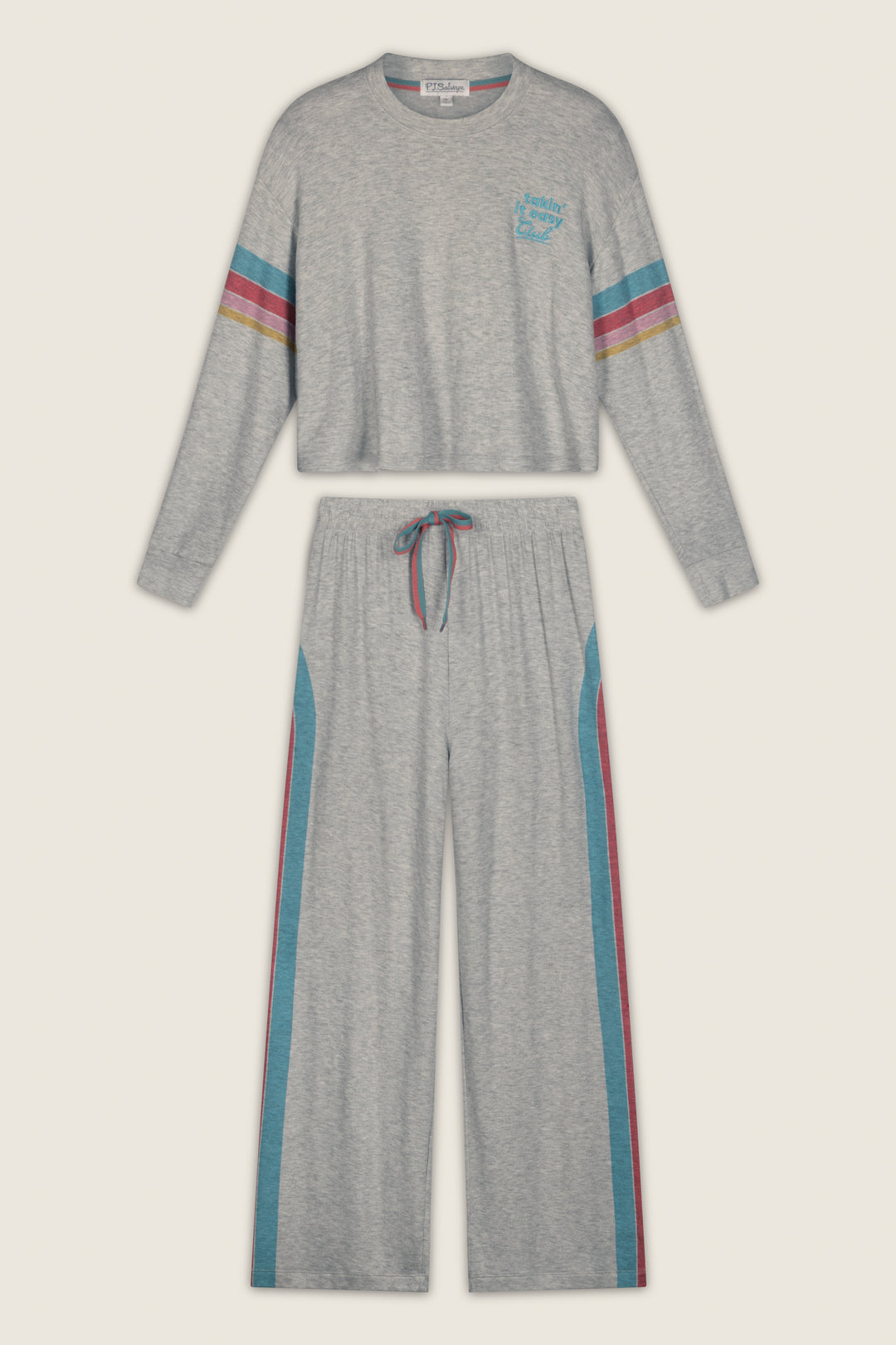 The Takin’ It Easy Club Striped Lounge Set by P.J. Salvage features a gray long-sleeve top with a small chest graphic on the left side and matching pants with rainbow stripes along the sleeves and pant legs. The pants include a drawstring waist and teal side panels for added style.