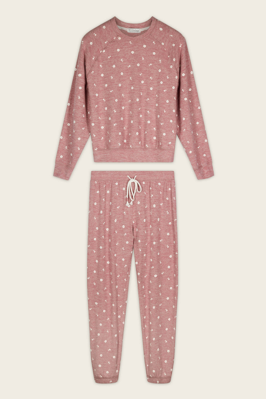The Tiny Blooms Polka Dot Long Sleeve PJ Set by P.J. Salvage, featuring a long-sleeve top and drawstring pants in pink with white polka dots, is laid flat on a plain background.
