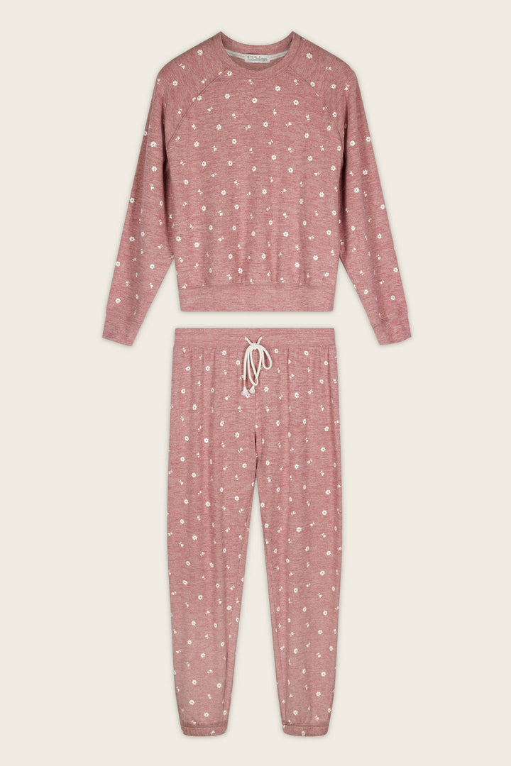 The Tiny Blooms Polka Dot Long Sleeve PJ Set by P.J. Salvage, featuring a long-sleeve top and drawstring pants in pink with white polka dots, is laid flat on a plain background.
