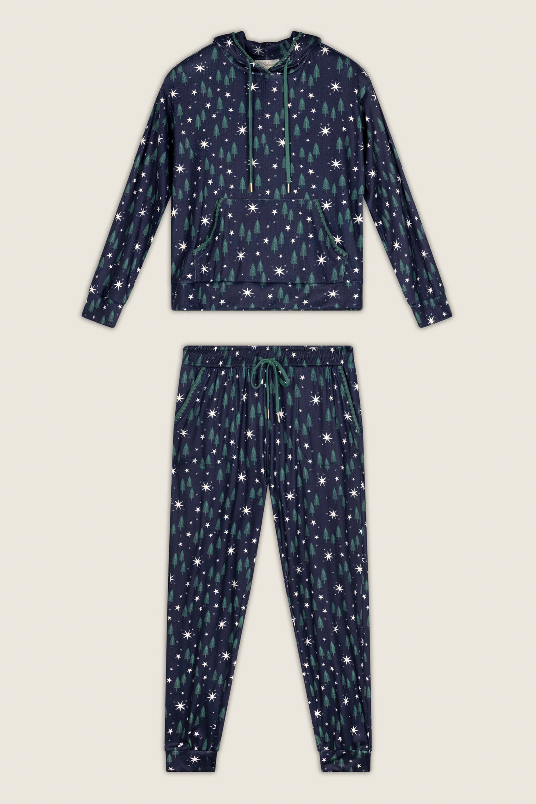 The Under the Stars Magical Forest Print Hoodie & Jogger Set by P.J. Salvage features a navy blue pajama set with a hoodie and pants, both adorned with a pattern of green Christmas trees and white stars.