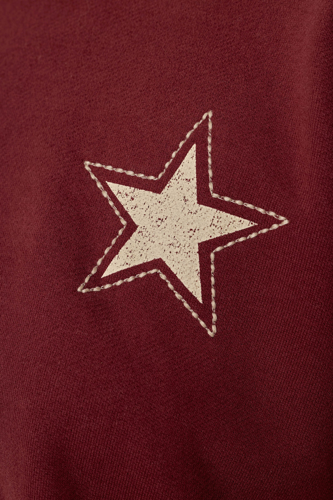 A white star with a stitched border is printed on the textured, dark wine fabric of the Western Ways BFF Lounge Pants by P.J. Salvage.