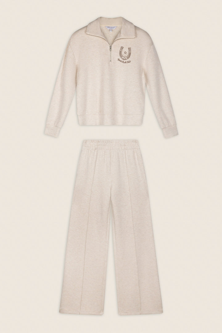 P.J. Salvage Western Ways Good Luck Club Over Night Pullover in beige, a long-sleeve zip-up top with a horseshoe emblem on the chest, paired with matching loose-fit elastic waistband pants, displayed flat against a neutral background.