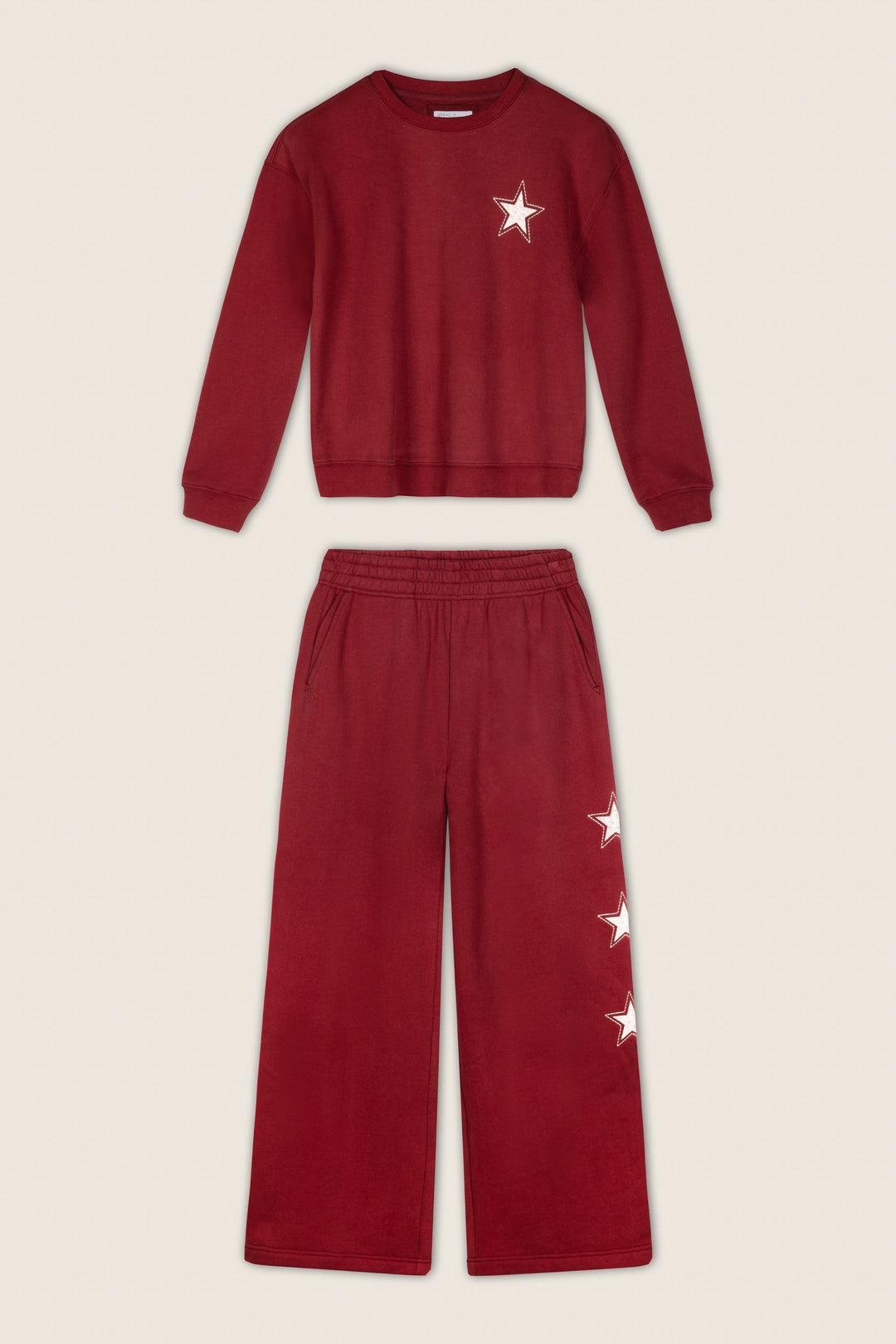 The P.J. Salvage Western Ways Dark Wine Simone Sweatshirt and matching wide-leg pants set features white star designs—one on the chest of the sweatshirt and two on the left pant leg—displayed against a light beige background.