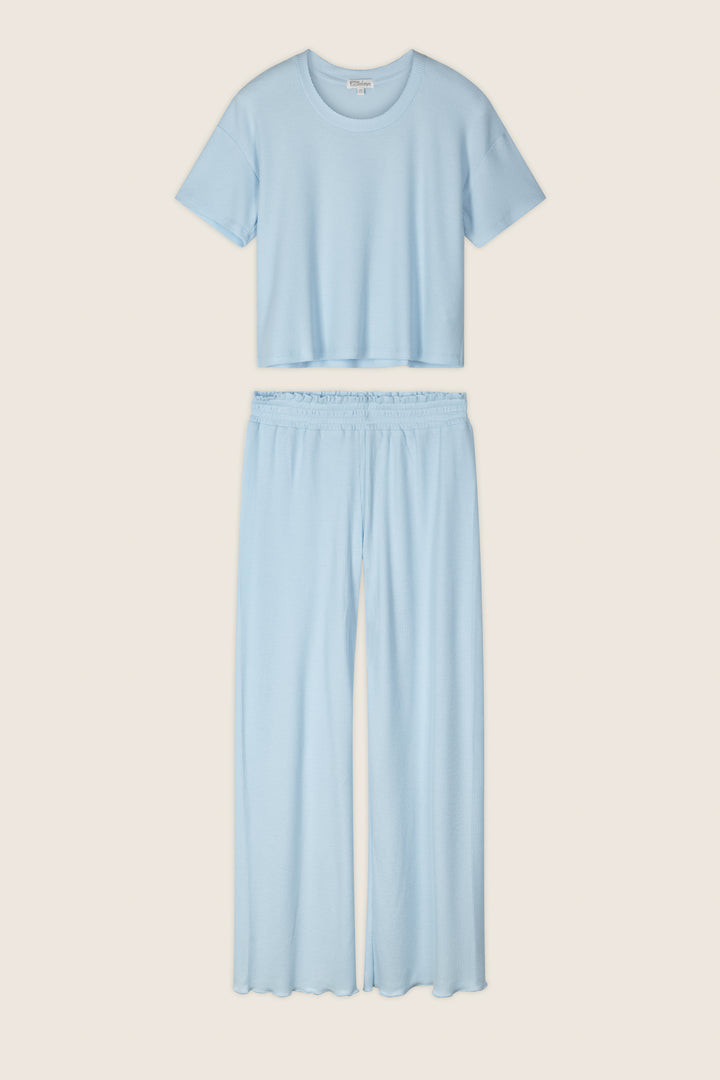 The P.J. Salvage Weekend Waffles Crystal Blue Long PJ Set includes a round-neck cropped top and wide-leg pants, shown flat on a neutral background—ideal for comfortable loungewear.
