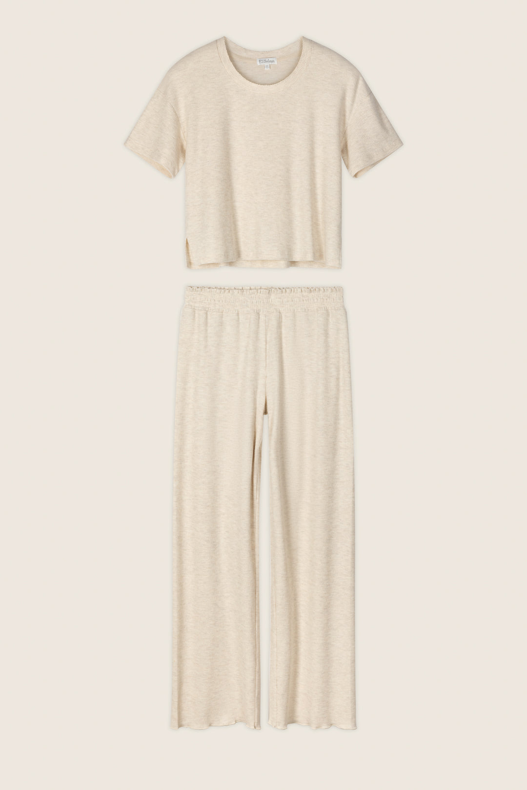 The P.J. Salvage Weekend Waffles Light Oatmeal Long PJ Set includes a short-sleeve, crew-neck crop top and high-waisted, wide-leg pants in soft waffle fabric—ideal for cozy nights—shown against a neutral background.