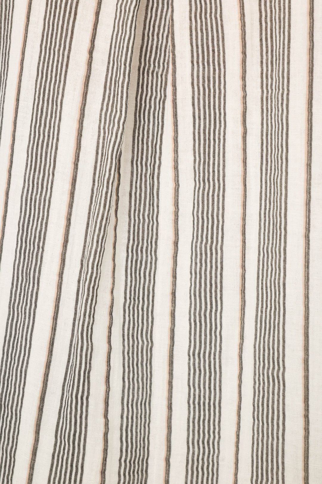 Close-up of the P.J. Salvage Sea You in St. Tropez Shoreline Stripe Shorts' cotton double gauze fabric, featuring vertical black and light brown stripes on off-white for a textured, relaxed vacation-ready look.
