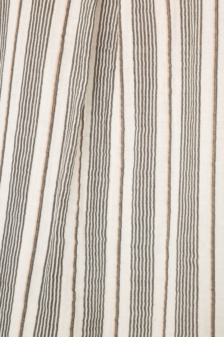 Close-up of the P.J. Salvage Sea You in St. Tropez Shoreline Stripe Shorts' cotton double gauze fabric, featuring vertical black and light brown stripes on off-white for a textured, relaxed vacation-ready look.