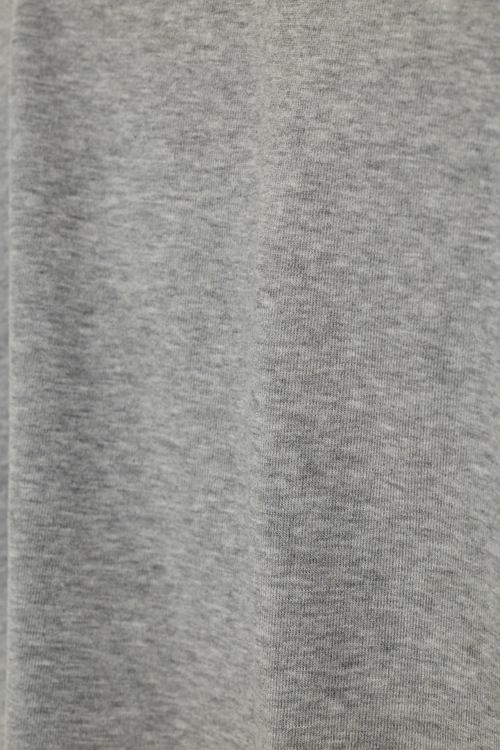 Close-up of a heather gray knit fabric texture with soft vertical folds.