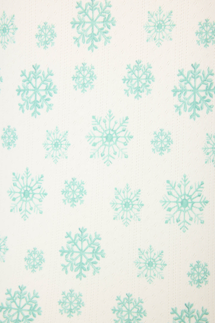 The Snowflake Wishes Pointelle Pants Set by P.J. Salvage features a white base with a repeating pattern of blue-green snowflakes in varying sizes, evenly spaced across the fabric for a cozy winter look.