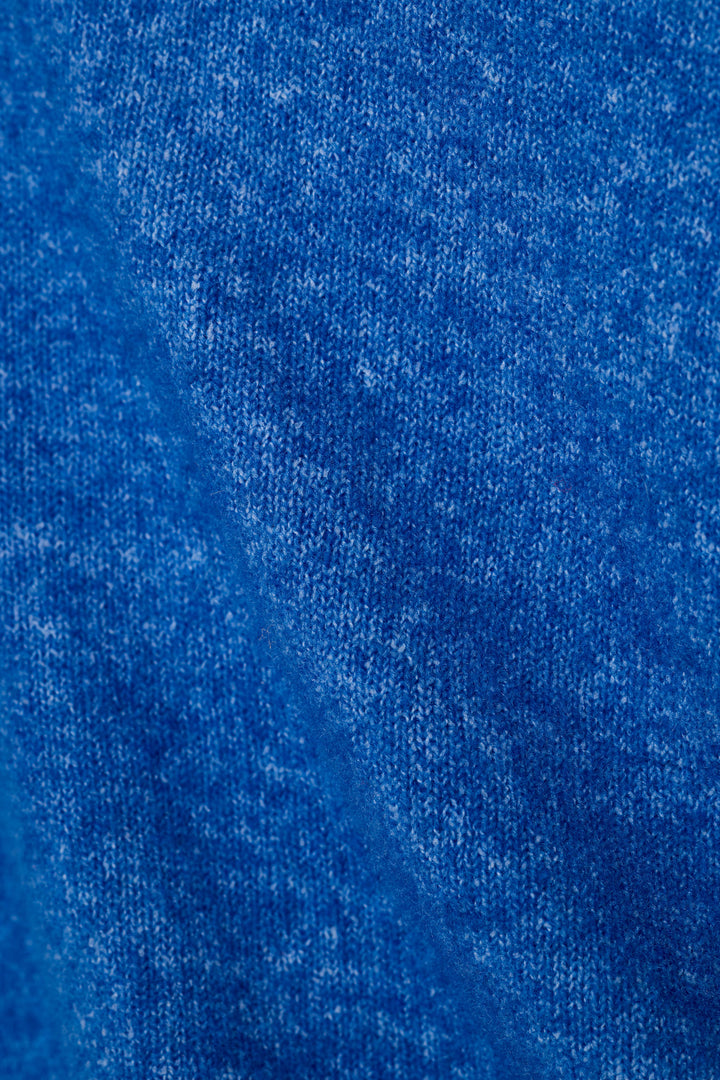 A close-up of a heathered royal blue sweater fabric texture, showing the detailed weave and color variation.