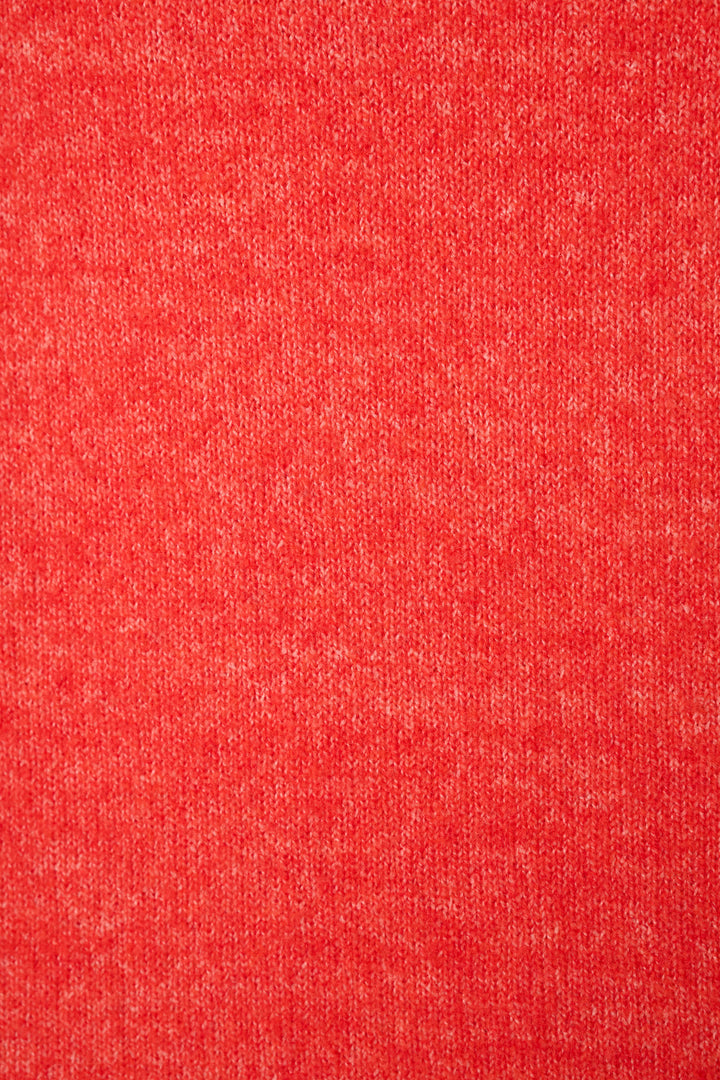 A close-up of a heathered red sweater fabric texture filling the entire frame.