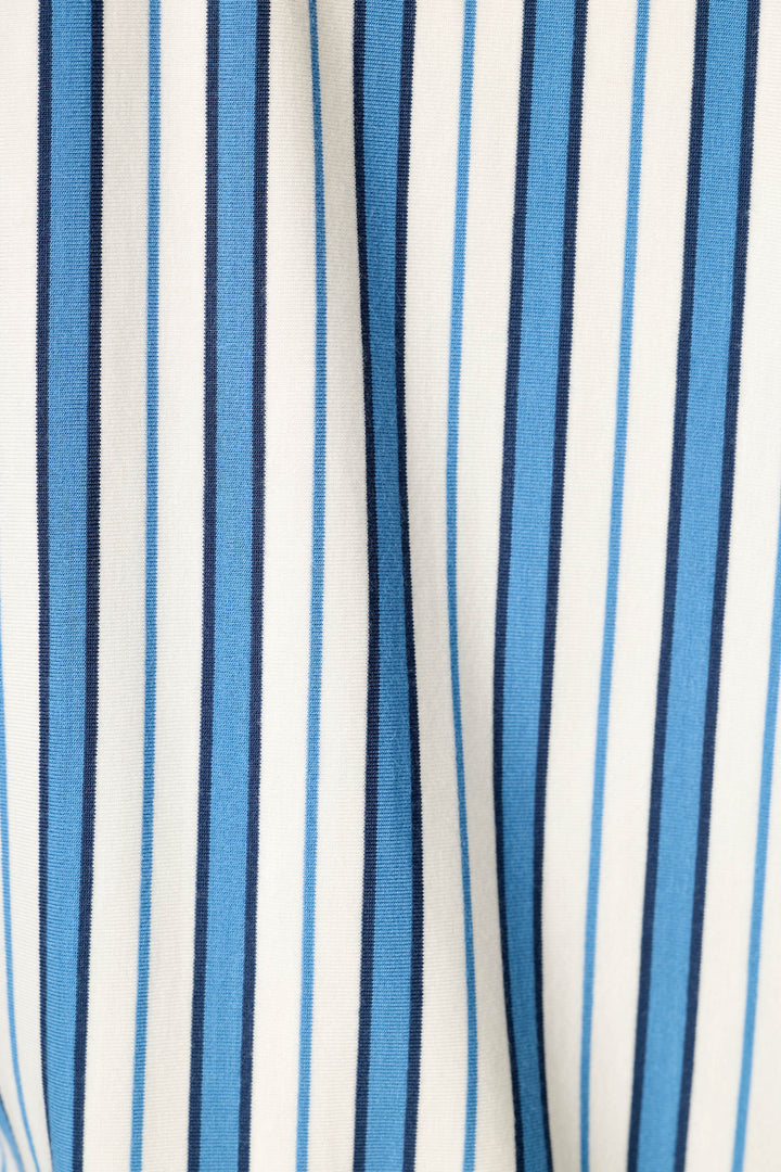 Close-up of a striped fabric with vertical blue, navy, and white stripes.