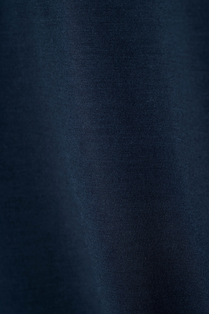 Close-up of the Soiree Dreams Deep Navy fabric, highlighting the soft, finely woven texture with gentle folds and subtle shadows.