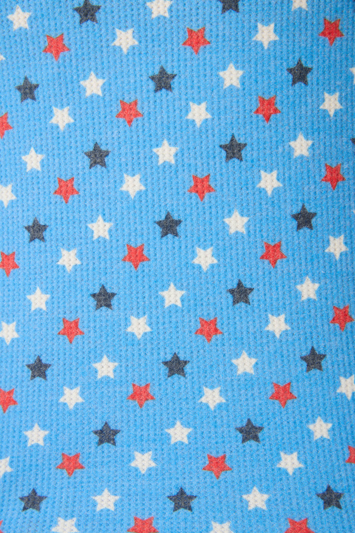 Blue textured fabric with red, white, and black five-pointed stars arranged in a regular grid pattern.