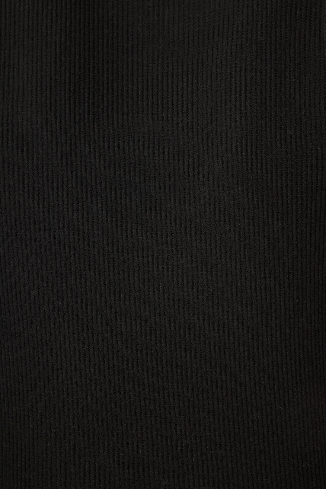 A close-up of the black ribbed fabric texture from Textured Essentials by P.J. Salvage, showcasing vertical lines and soft folds.