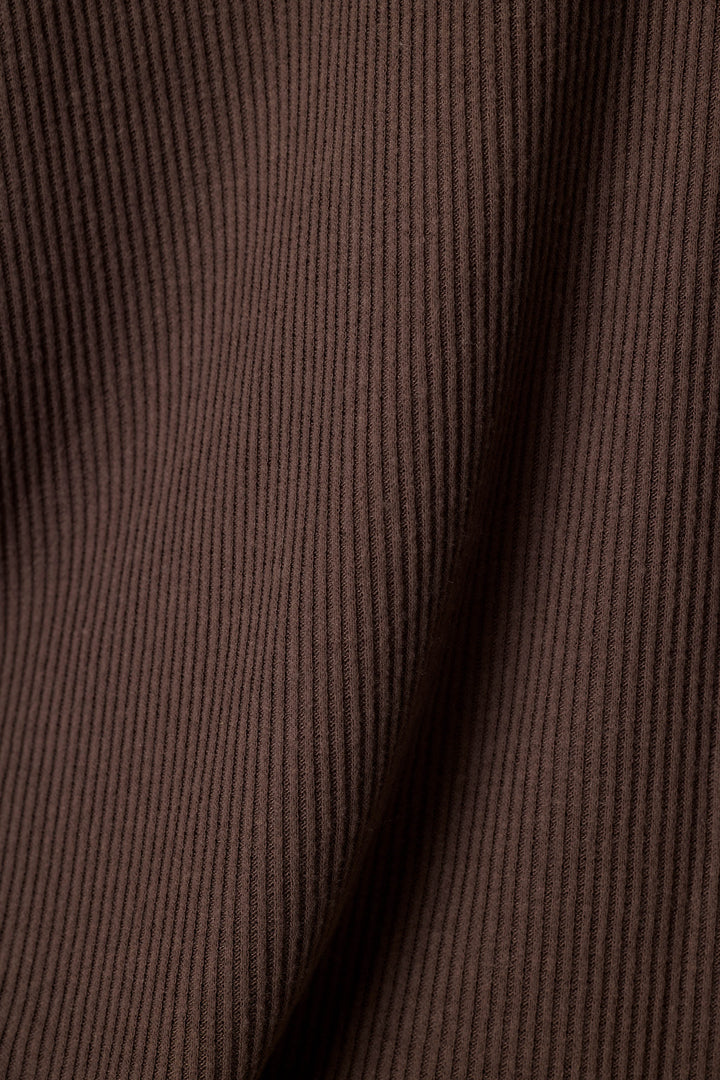 Close-up of a dark brown ribbed fabric texture with soft folds and vertical ridges.