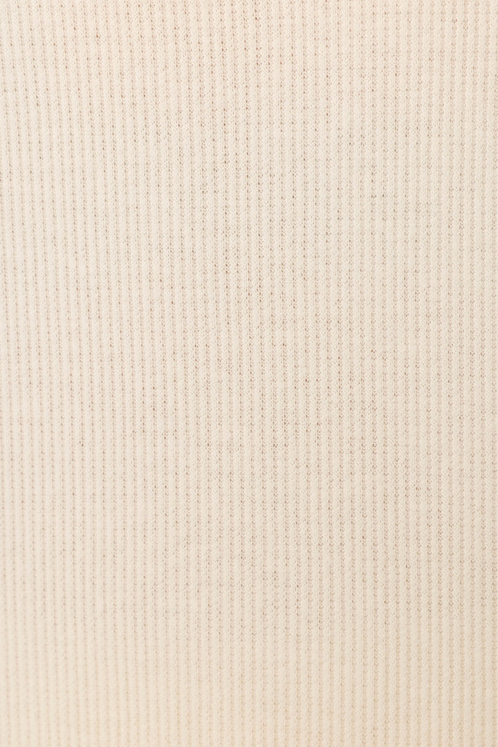 Close-up of the soft, beige rib knit fabric from P.J. Salvage's Textured Essentials Stone Long PJ Set, featuring evenly spaced vertical lines—ideal for cozy loungewear.