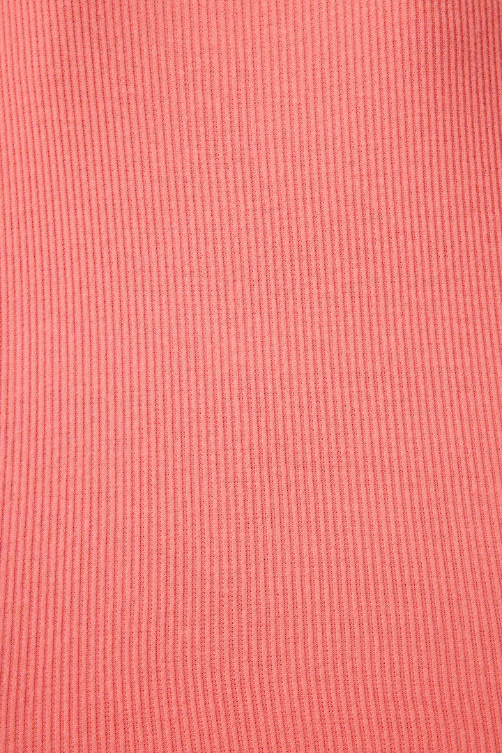 Close-up of the Textured Essentials Sunset Rose Long PJ Set by P.J. Salvage, featuring solid pink rib knit fabric with vertical lines and an even texture.