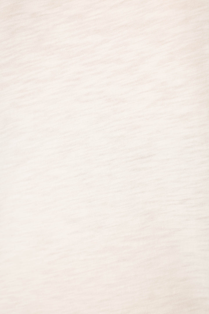 Light beige cotton-modal slub jersey fabric with a subtle, slightly textured pattern; smooth and evenly lit, no visible prints.