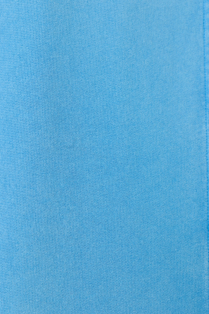 Close-up of the P.J. Salvage Washed Away Marine Blue Shirt Jacket fabric shows a smooth, evenly colored surface with subtle ribbed texture and fine vertical lines, making it ideal for a relaxed, stylish look.