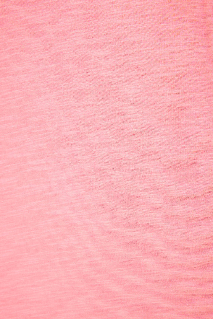 A close-up of the Western Blooms Howdy Darlin Graphic Print T-Shirt by P.J. Salvage shows pink fabric with a subtle, heathered texture and soft color variations throughout.