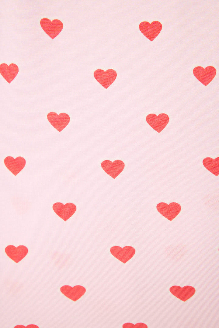 The Wildest Dreams Heart Print Shorts Set by P.J. Salvage features an evenly spaced red heart pattern on a light pink background.
