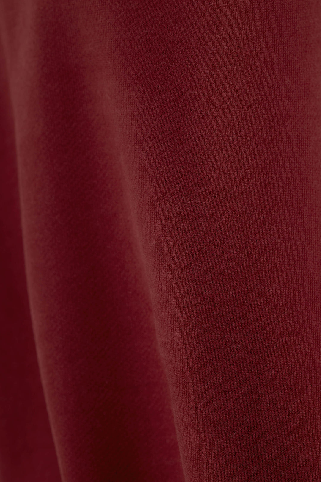 A close-up view of the Western Ways Dark Wine fabric, highlighting the soft texture and subtle shading of the deep maroon fabric.