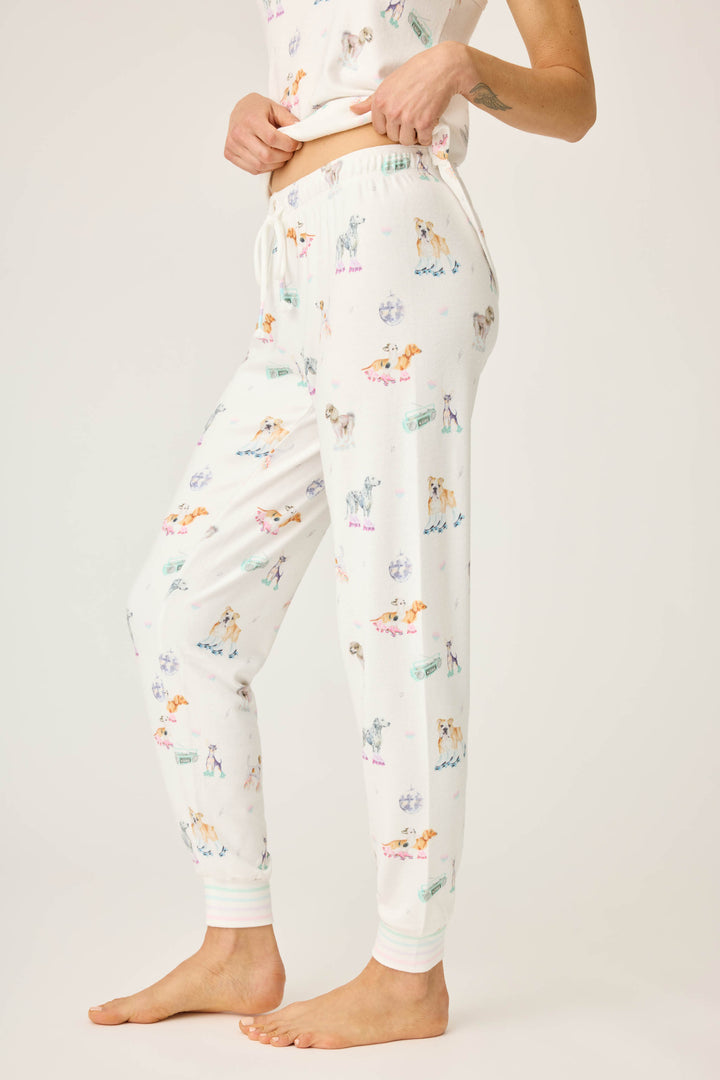 Women's ivory pajama pant with dogs on rollerskates pattern. Relaxed fit with banded bottom.