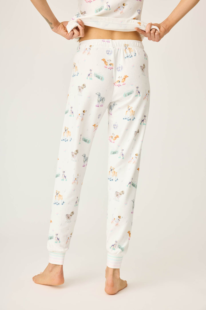 Women's ivory pajama pant with dogs on rollerskates pattern. Relaxed fit with banded bottom.