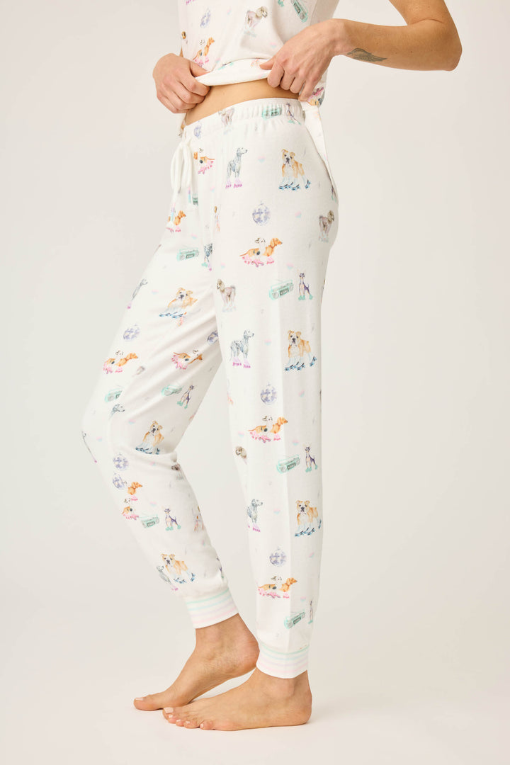 Women's ivory pajama pant with dogs on rollerskates pattern. Relaxed fit with banded bottom.