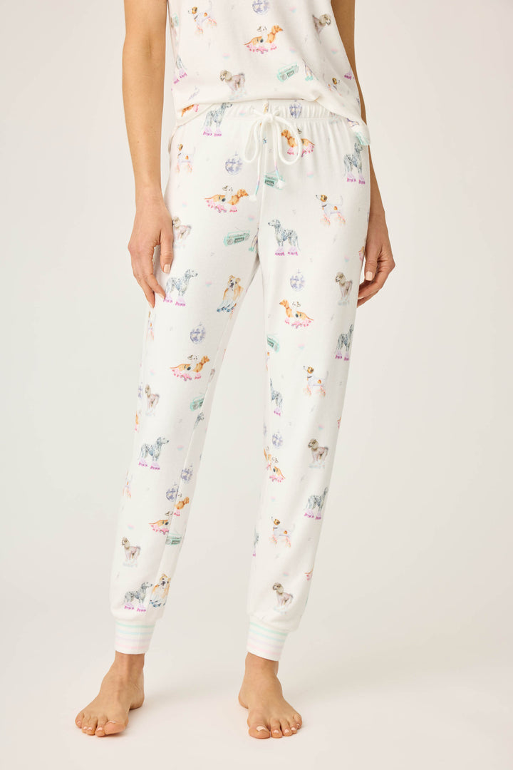 Women's ivory pajama pant with dogs on rollerskates pattern. Relaxed fit with banded bottom.