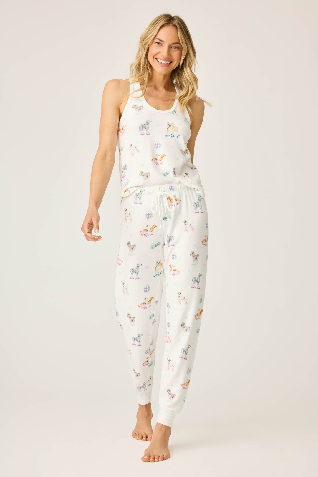 Women's ivory pajama pant with dogs on rollerskates pattern. Relaxed fit with banded bottom.