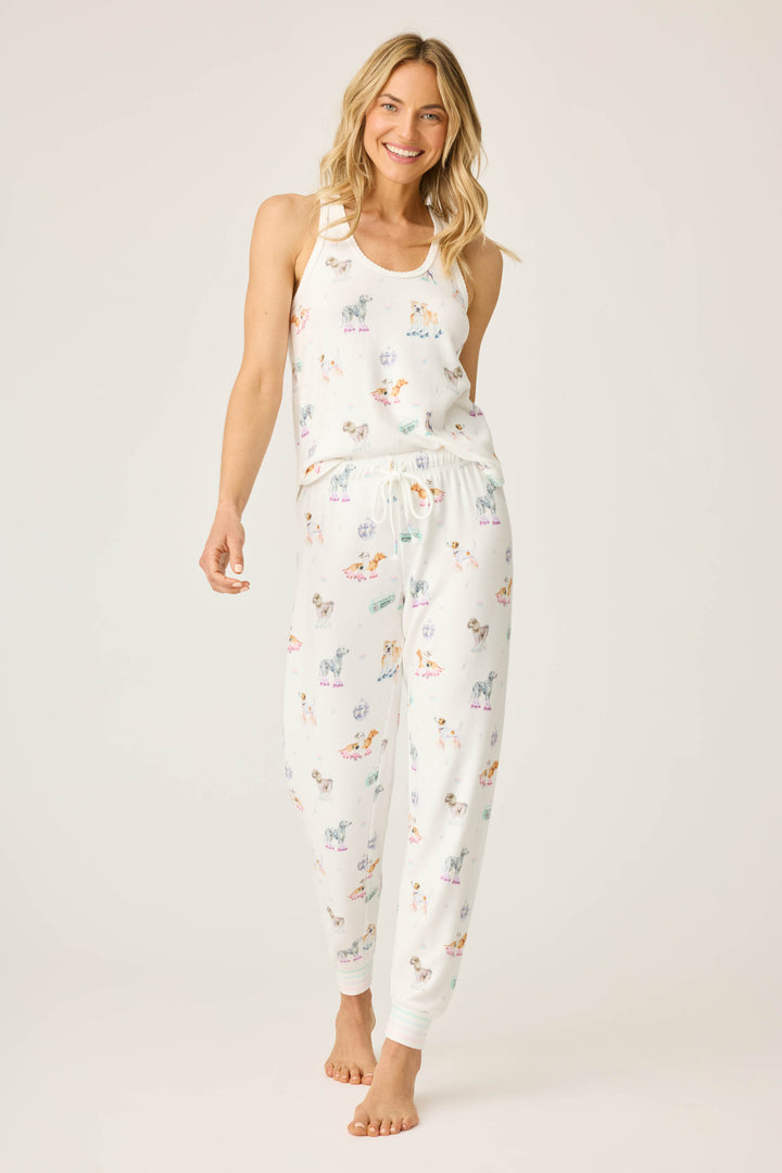 Women's ivory pajama pant with dogs on rollerskates pattern. Relaxed fit with banded bottom.