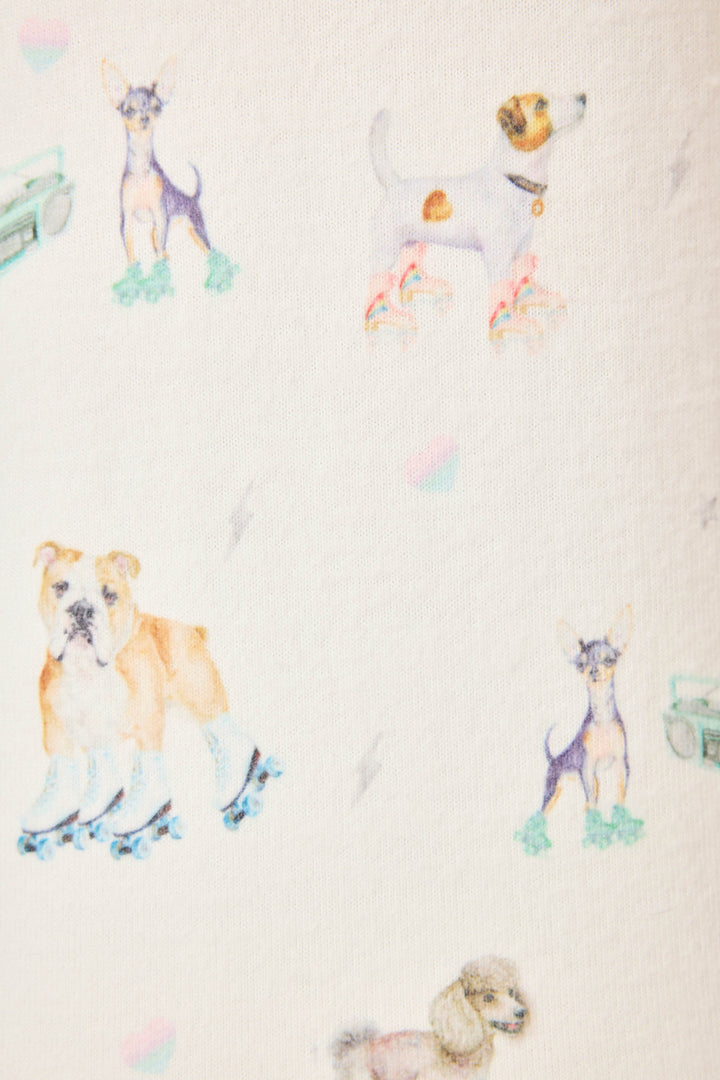 Women's ivory pajama pant with dogs on rollerskates pattern. Relaxed fit with banded bottom.