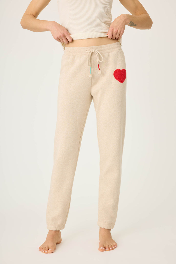 Women's oatmeal jogger pant with red boucle heart applique. Oatmeal cloud terry with tie waist.